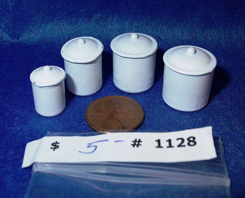 SOLD    

$5  -  Item #1128 
White Metal Canister Set of 4 with lids