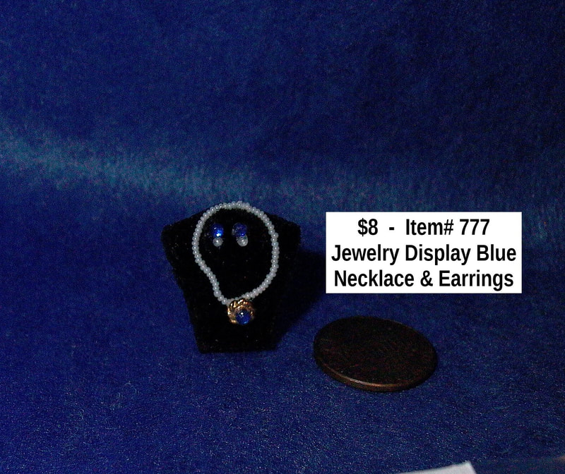 $8  -  Item# 777  - Jewelry Display with Necklace and Earrings in Blue